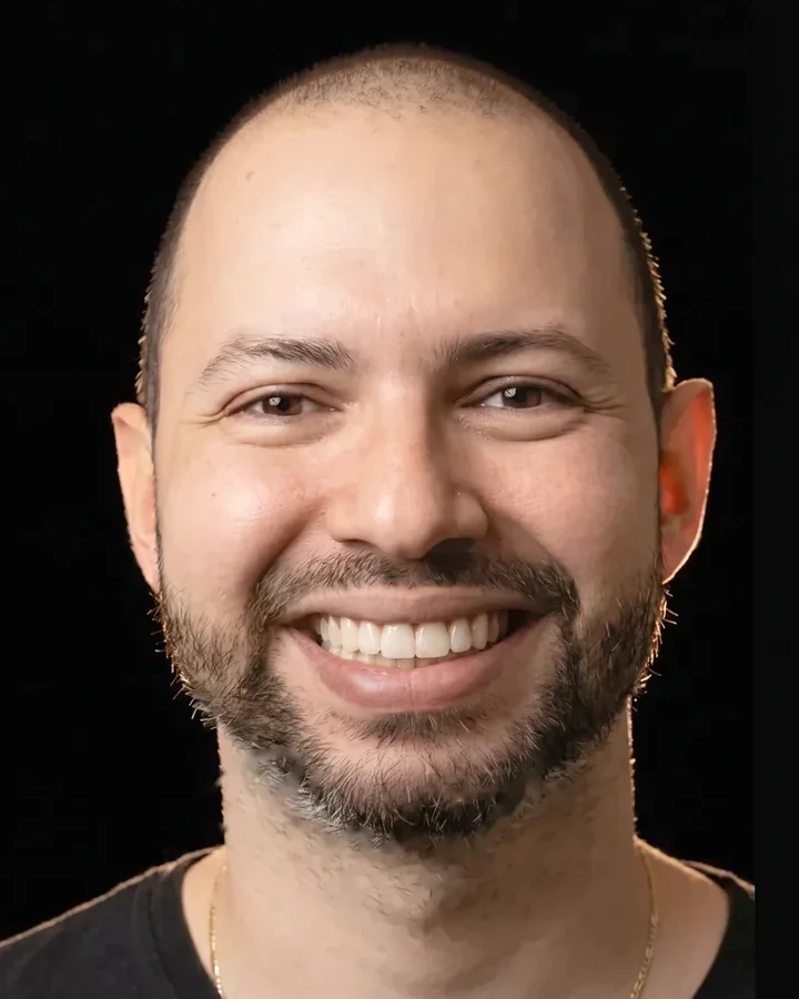 Studio reconstruction of a patient with a broad smile, ceramic smile design on a black background